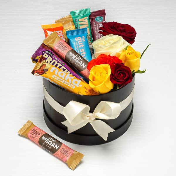 A hat gift box with flowers and vegan snacks